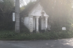 mysterious chapel at a crossroads in the mist